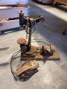 Wooden crate with antique tools - crank grinder, pulley, and more