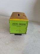 John Deere plate, die-cast model car, and International model tractor