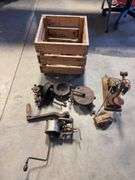 Wooden crate with antique tools - crank grinder, pulley, and more