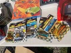 Box of mostly new cars/ toys including hot rod hauler, racing Champions car, BP Chopper Truck and mo