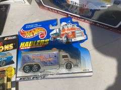 Box of toy tractors/cars/trucks and Ford pocketknife