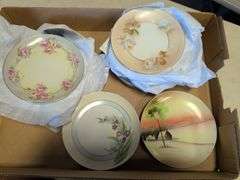 Assortment of decorative plates and glass decor