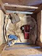 Wooden crate with antique tools - crank grinder, pulley, and more