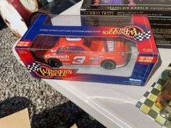 Box of mostly new cars/ toys including hot rod hauler, racing Champions car, BP Chopper Truck and mo