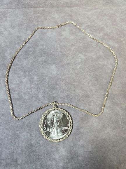 1987 SILVER EAGLE IN STERLING BEZEL AND NECKLACE