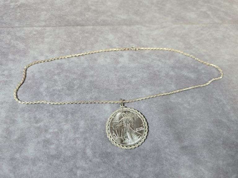 1987 SILVER EAGLE IN STERLING SILVER BEZEL AND NECKLACE